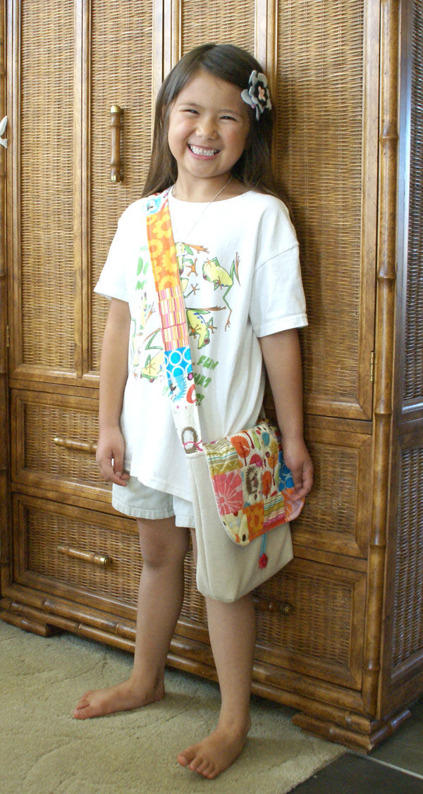 kid with patchwork art bag